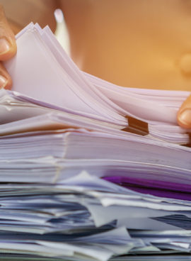 Businesswoman hands working in Stacks of paper files for searching information on work desk office, business report papers,piles of unfinished documents achieves with clips indoor,Business concept