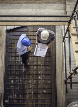 Construction workers and architects viewed from above