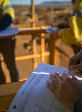 Safety supervisor checking and reviewing document before issued sigh of working at height permit