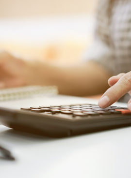 close up grandmother hand press on calculator for counting about monthly expense or planning money management after retired concept