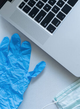 Pandemic work kit on white office desk with hand sanitizer, face mask and gloves. Corona virus covid-19 pandemic outbreak prevention