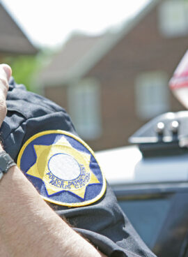 Police officer using radio to call for backup