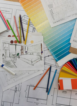 Blue prints, color swatch, pencil colors, sketches, plans and documents for a home renovation