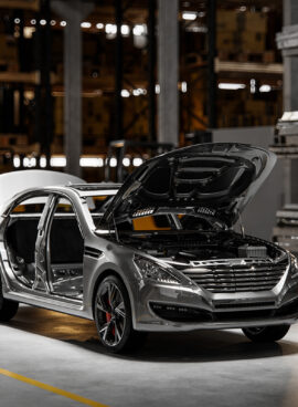 Cars on assembly line in plant