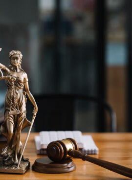 Statue of lady justice on desk of a judge or lawyer.