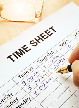 Records work hours in a time sheet.