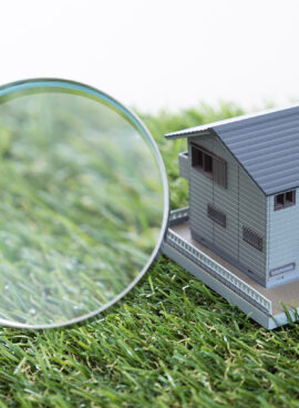 House model and magnifying glass